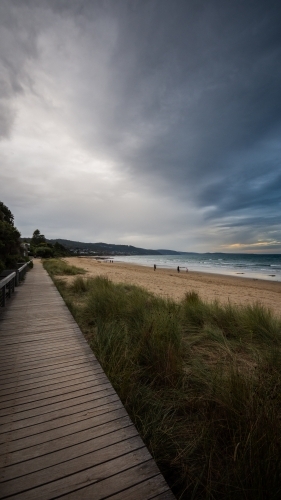Beachside Boardwalk under a Stormy Sky