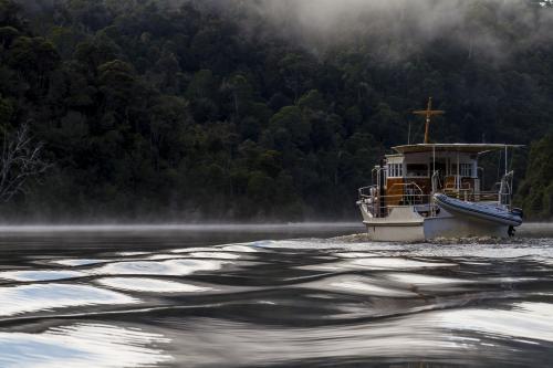 Beautiful old wooden boat on the water from behind - Australian Stock Image