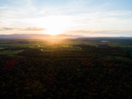 Beautiful sunset light over landscape of trees and farm land in Hunter Valley - Australian Stock Image