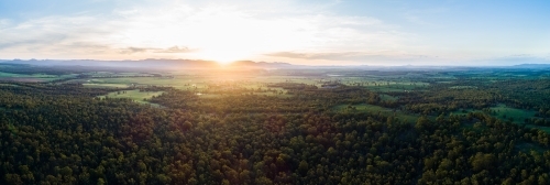 Beautiful sunset light over landscape of trees and farm land in Hunter Valley - Australian Stock Image