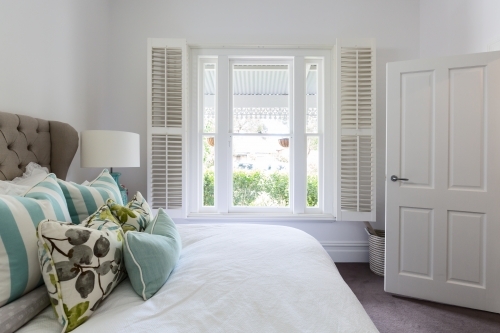 Bedroom window with a garden view in a luxury country house bedroom - Australian Stock Image