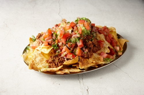 Beef nachos dish on table - Australian Stock Image