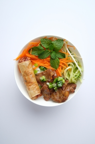 Beef noodle salad topped with fried lumpia - Australian Stock Image