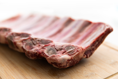 beef ribs on a chopping board ready to cook - Australian Stock Image