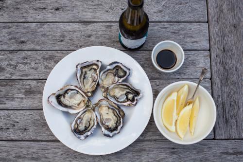 beer and oysters on outdoor table - Australian Stock Image