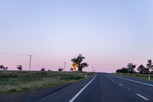 Bend in road coming up with recommended speed of 85 kph - Australian Stock Image
