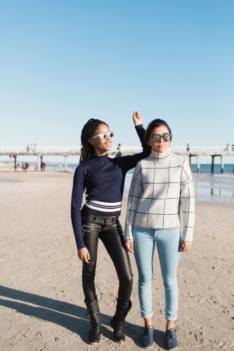 Best friends spending time on the beach laughing - Australian Stock Image