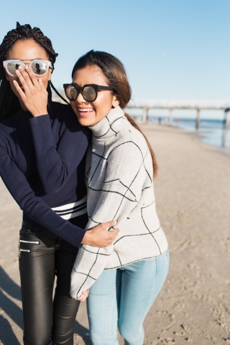 Best friends spending time on the beach laughing - Australian Stock Image