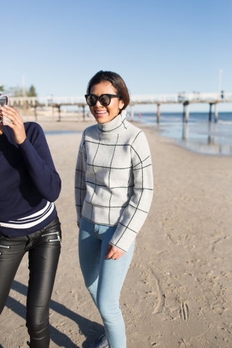 Best friends spending time on the beach laughing - Australian Stock Image