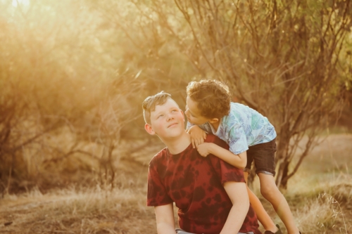 Big and little brother mucking around in the Australian bush - Australian Stock Image