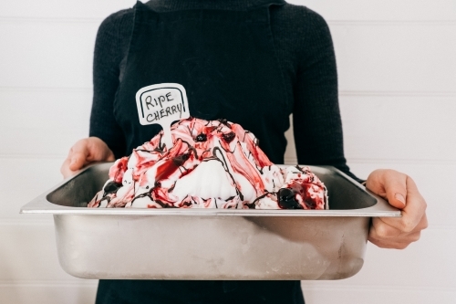 Big bucket of fresh made cherry ice cream. - Australian Stock Image
