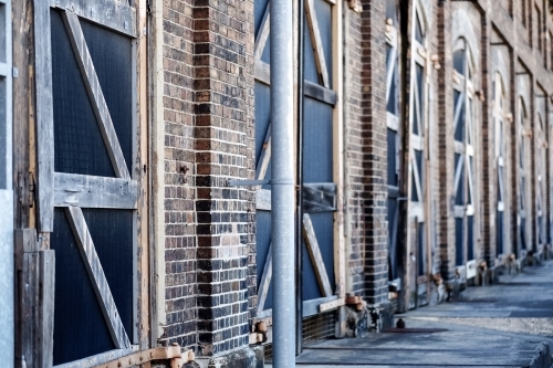 big old doors, closed and lined up at a warehouse - Australian Stock Image