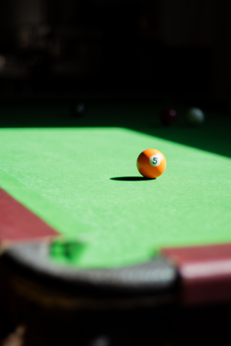 Billiards ball on pool table mid-game - Australian Stock Image
