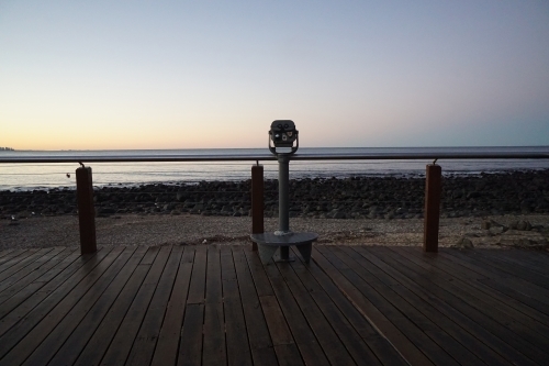 Binoculars look out over beach sunset - Australian Stock Image