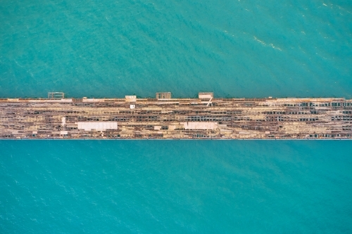 Bird's eye view of an old abandoned jetty in turquoise ocean water  - Kwinana Bulk Jetty - Australian Stock Image