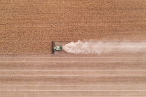 Birds eye view of header harvesting wheat - Australian Stock Image