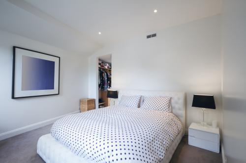 Black and white master bedroom with walk in wardrobe - Australian Stock Image