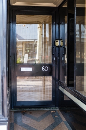 Black door with glass with number 60 - Australian Stock Image