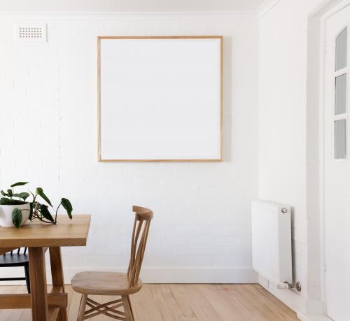 Blank framed print on white wall in beautiful danish styled interior dining room - Australian Stock Image