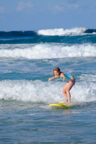 Blonde girl learning to surf on the Gold Coast - Australian Stock Image