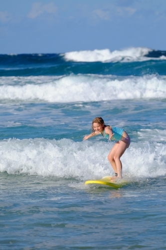 Blonde girl learning to surf on the Gold Coast