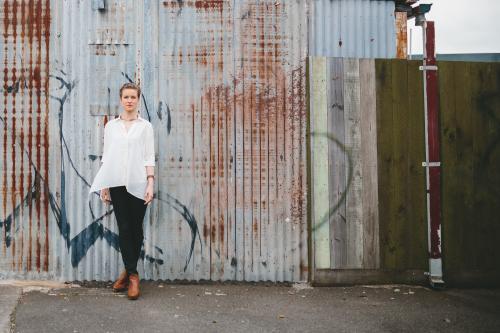 Blonde woman standing in a laneway - Australian Stock Image
