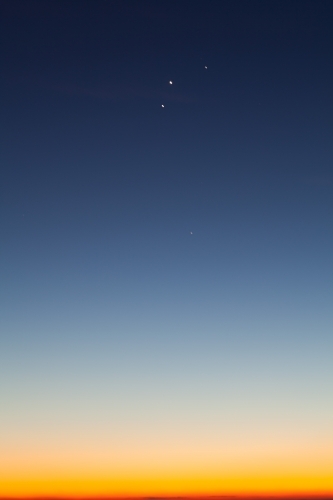Blue and yellow dawn sky with planets aligned - Australian Stock Image