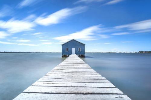 Blue boat house along Swan River - Australian Stock Image