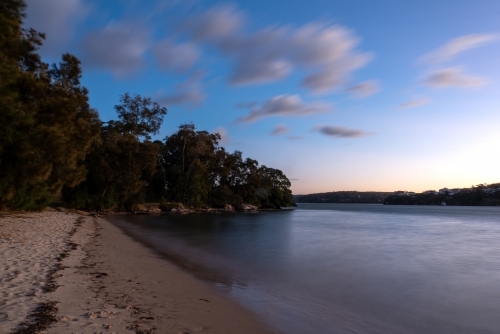Blue hour at beach with clouds in the sky - Australian Stock Image