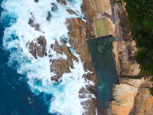 Blue Pool and ocean at Bermagui from above - Australian Stock Image