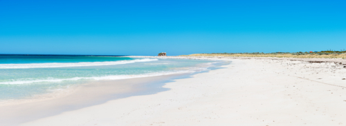 Blue skies white sands & turquoise ocean at two rocks beach - Australian Stock Image