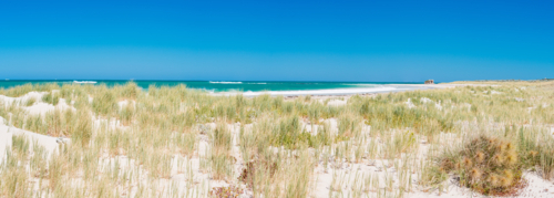 Blue skies white sands & turquoise ocean at two rocks beach - Australian Stock Image