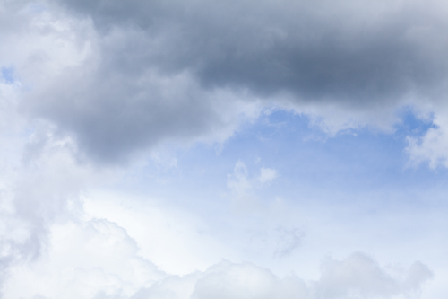 Blue spot of sky appearing through cloudy grey sky after rain - Australian Stock Image