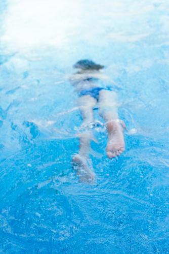 blurred image of a girl swimming in a pool