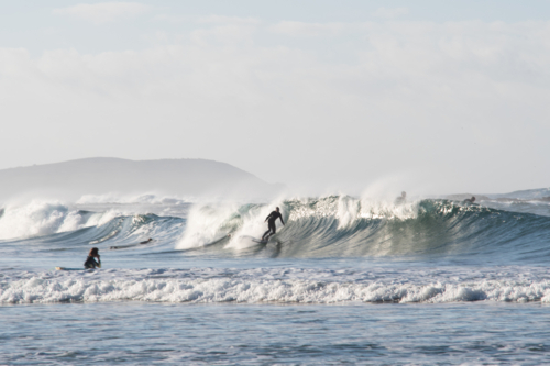 blurred surfer riding breaking wave - Australian Stock Image