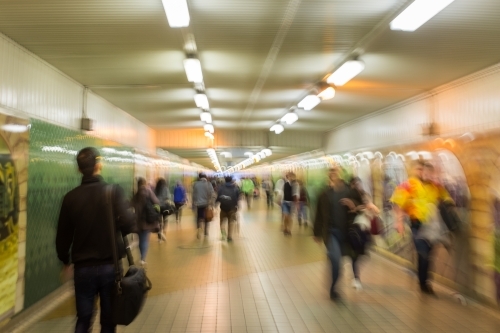 blurry motion abstract of people walking through an underground train station - Australian Stock Image
