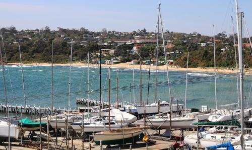 Boats beside ocean on a sunny day at Mount Martha beachfront - Australian Stock Image
