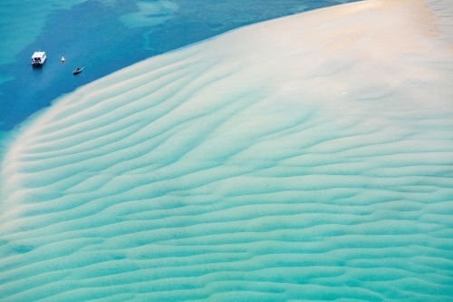 boats in channel near shallow sand bar - Australian Stock Image