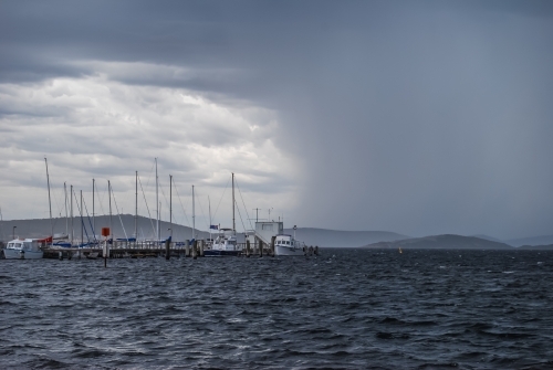 Boats moored in stormy weather