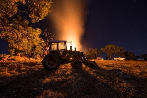 Bonfire behind tractor on farm
