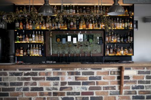 Bottles and beer taps behind bar at craft beer pub - Australian Stock Image