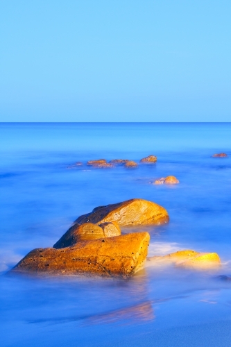 Boulders at the ocean's edge. - Australian Stock Image