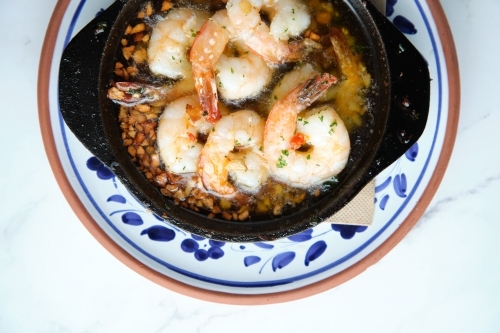 Bowl of shrimps sauteed in butter and garlic - Australian Stock Image