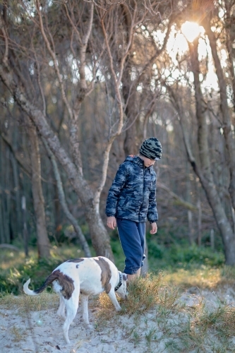 Boy and dog explore the remote coast of Queensland - Australian Stock Image