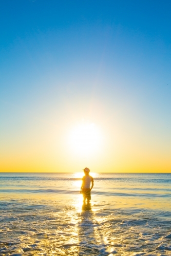 Boy at the beach at sunset, Port Willunga, Fleurieu Peninsula, South Australia