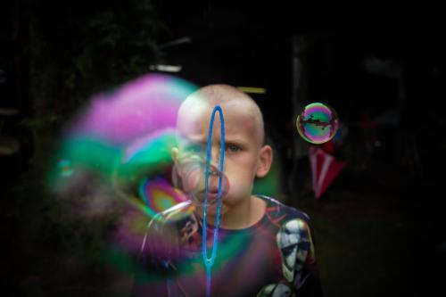 Boy blowing bubbles - Australian Stock Image