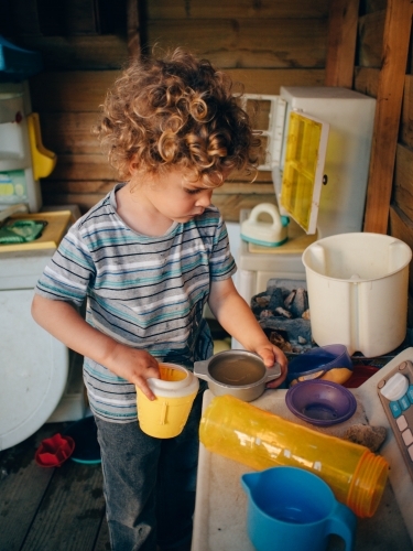 Boy playing in a cubby house - Australian Stock Image