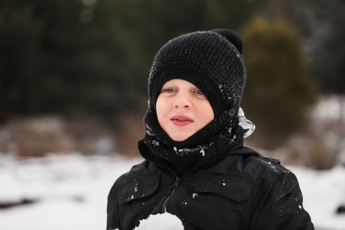 Boy playing in the snow. Winter at Shooter's Hill NSW - Australian Stock Image