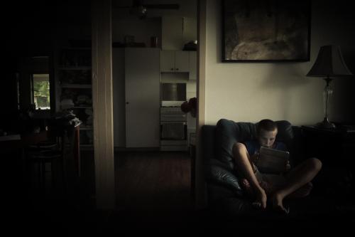 Boy staring into screen - Australian Stock Image