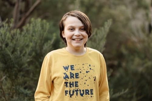 Boy wearing a generic yellow T-shirt that says we are the future - Australian Stock Image